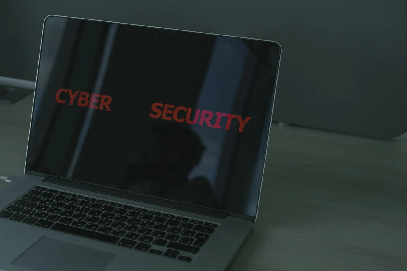 Close-up of a laptop displaying cybersecurity text
