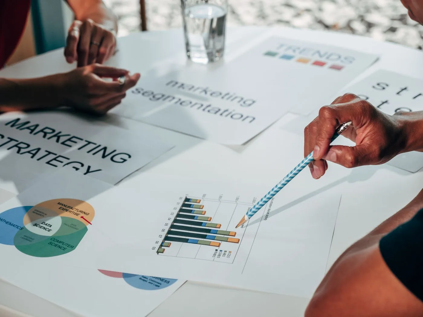 Team working on marketing strategy using data charts and papers in an office meeting