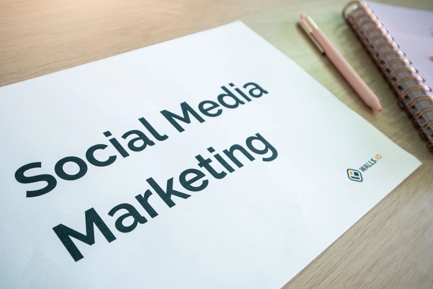 Close-up of a social media marketing document on a desk with a pen and notebook