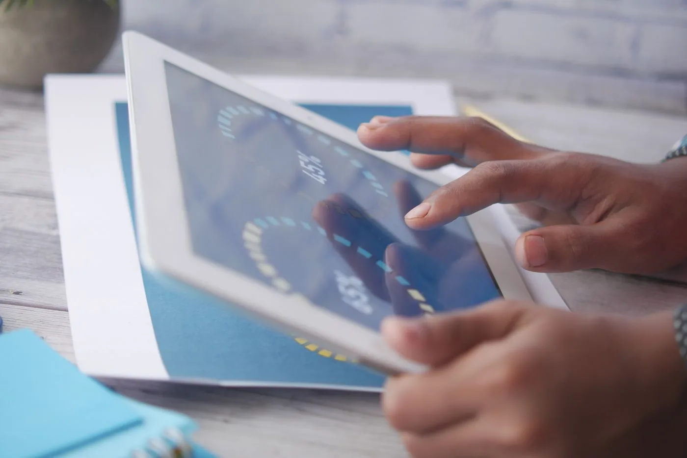 Hands interacting with a tablet
