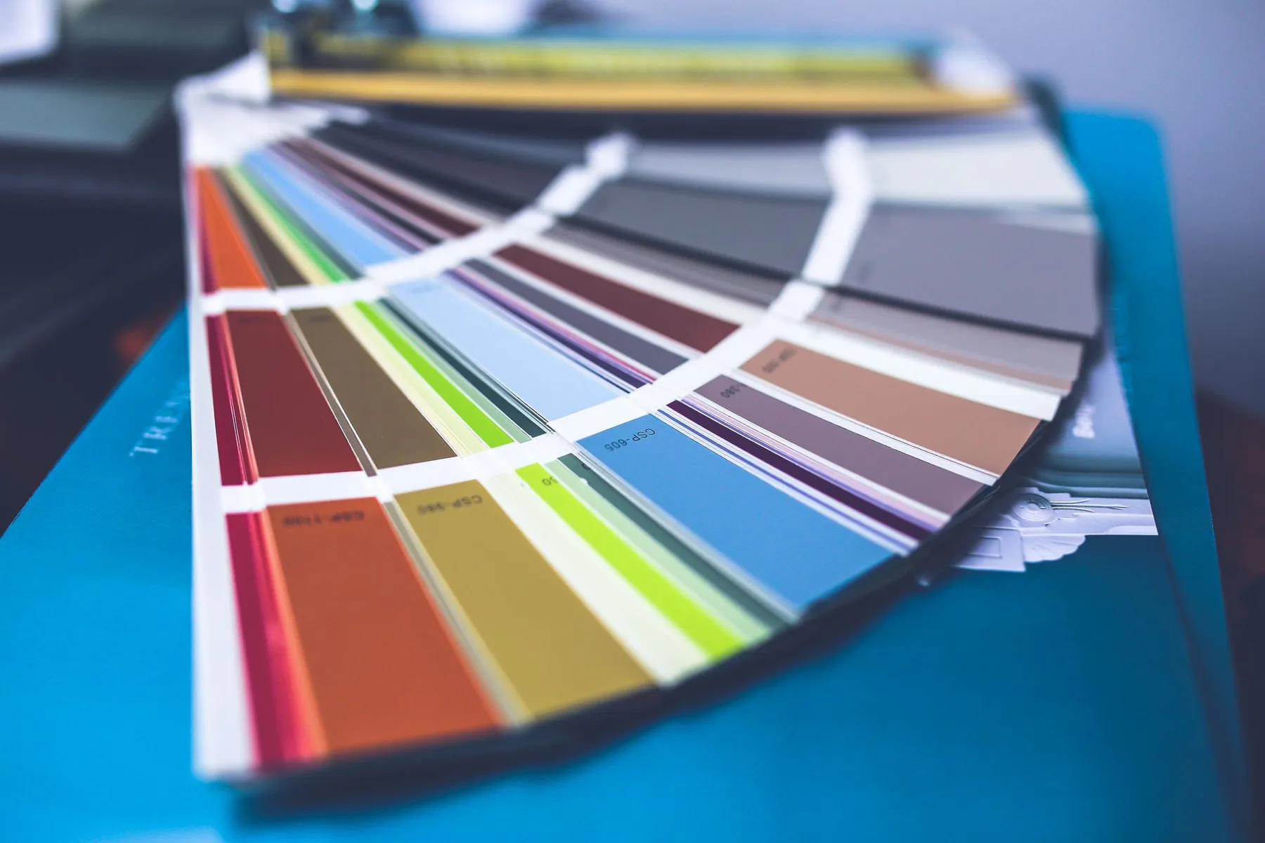 Close-up of a fanned-out color swatch deck used to choose a brand palette, part of custom branding design work.