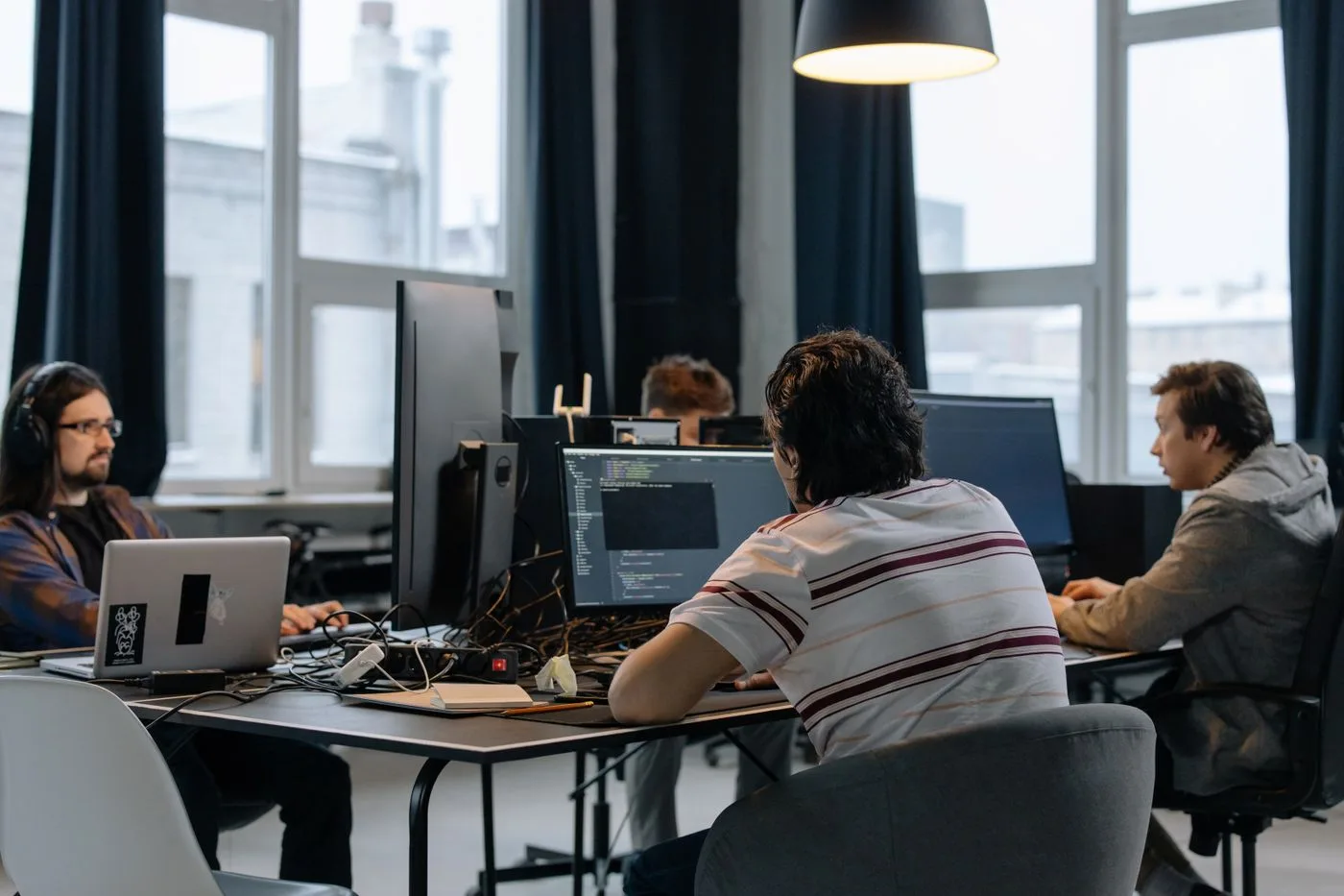 Team of developers working together on computers in a modern tech office