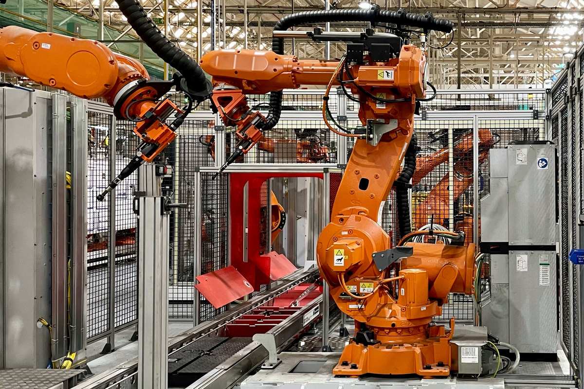 Industrial robotic arms in factory setting