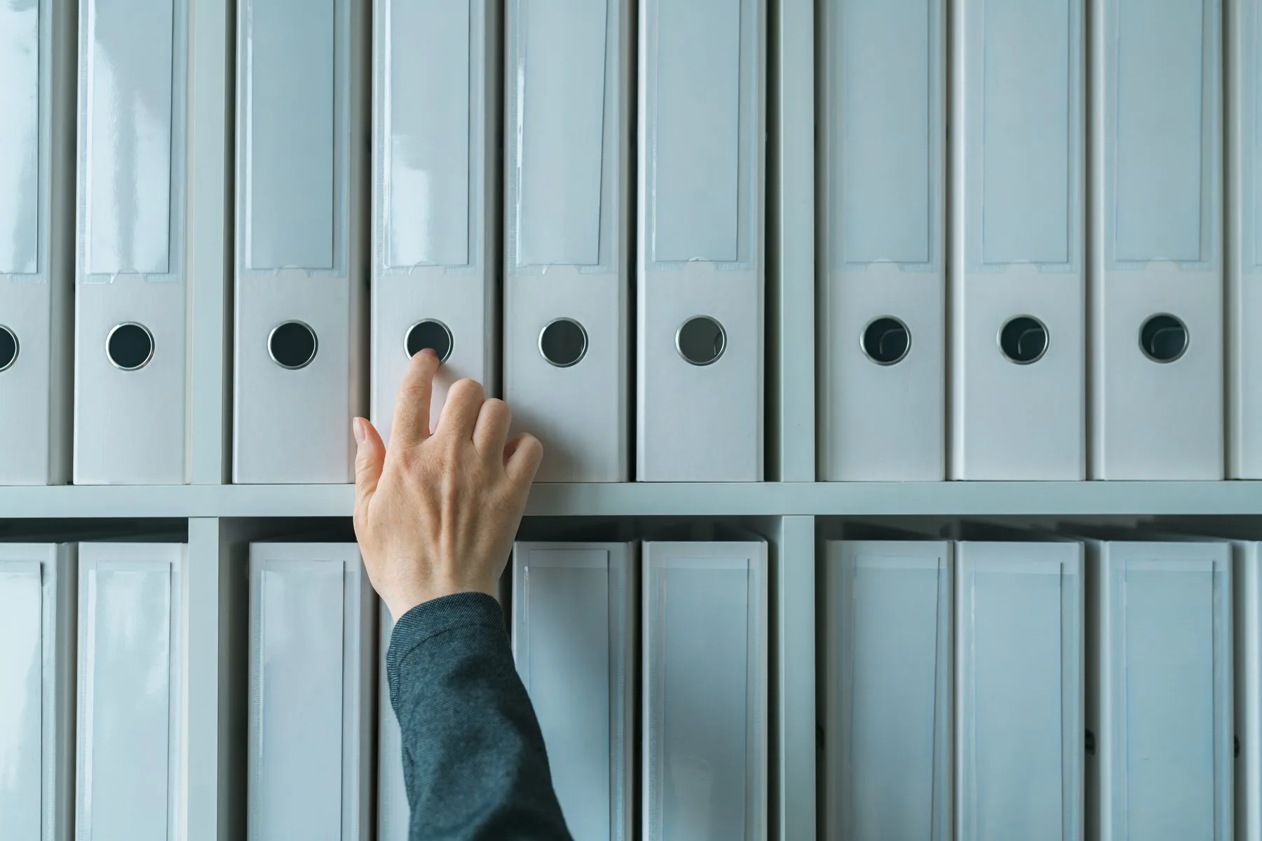 Hand selecting document file folder in office