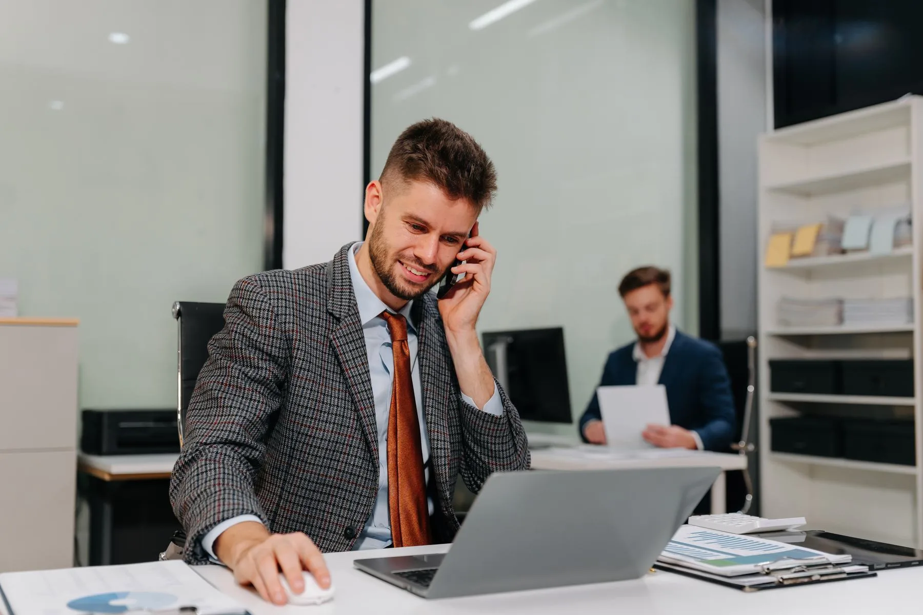 Professional man talking on phone while working