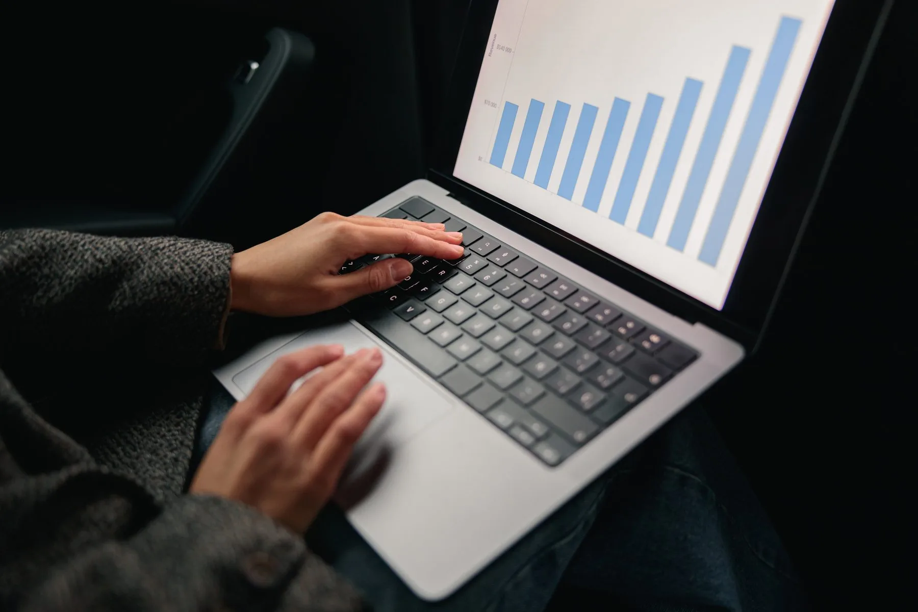 Business analysis graph on laptop inside vehicle