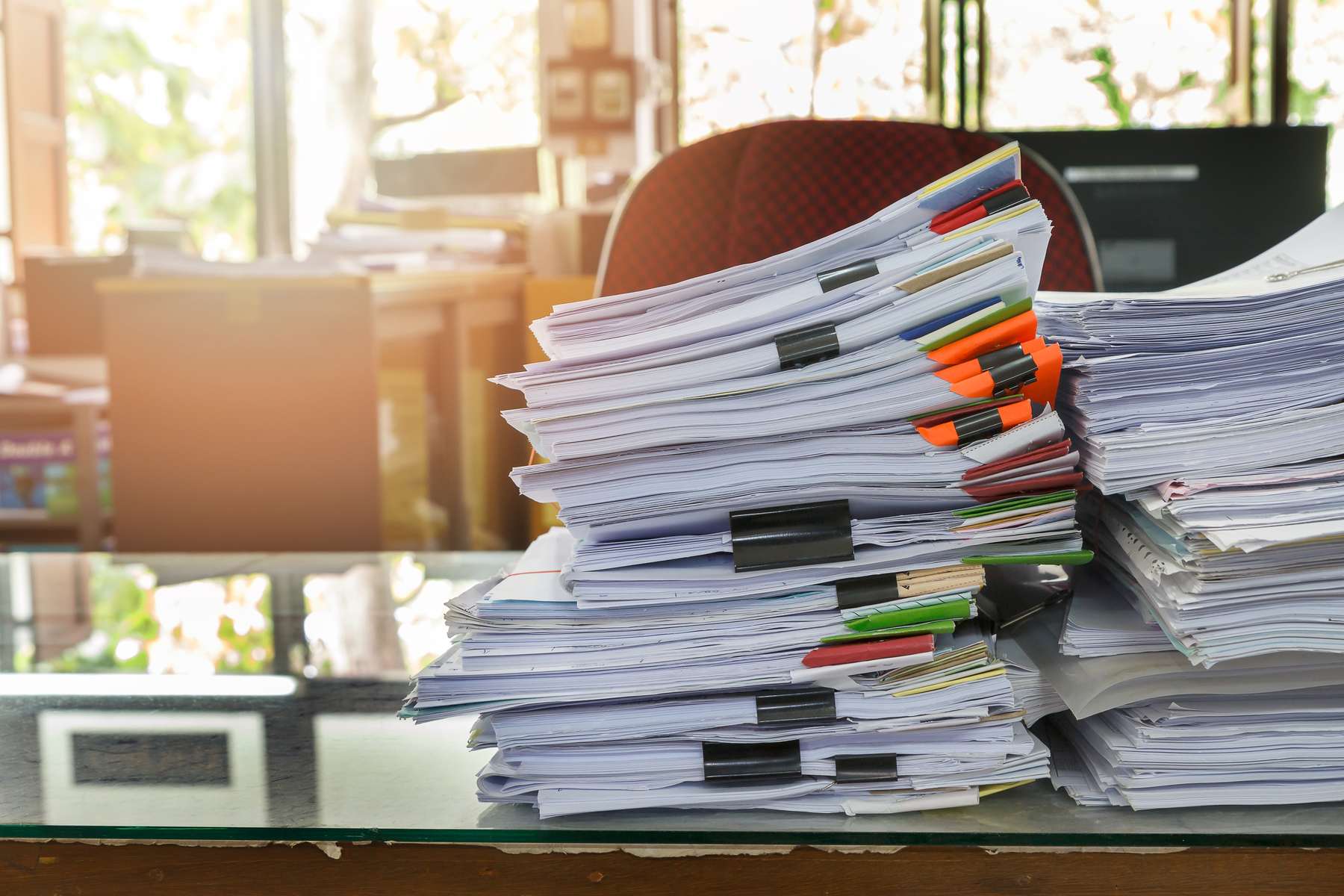 Stacks of paperwork dominate a tidy office