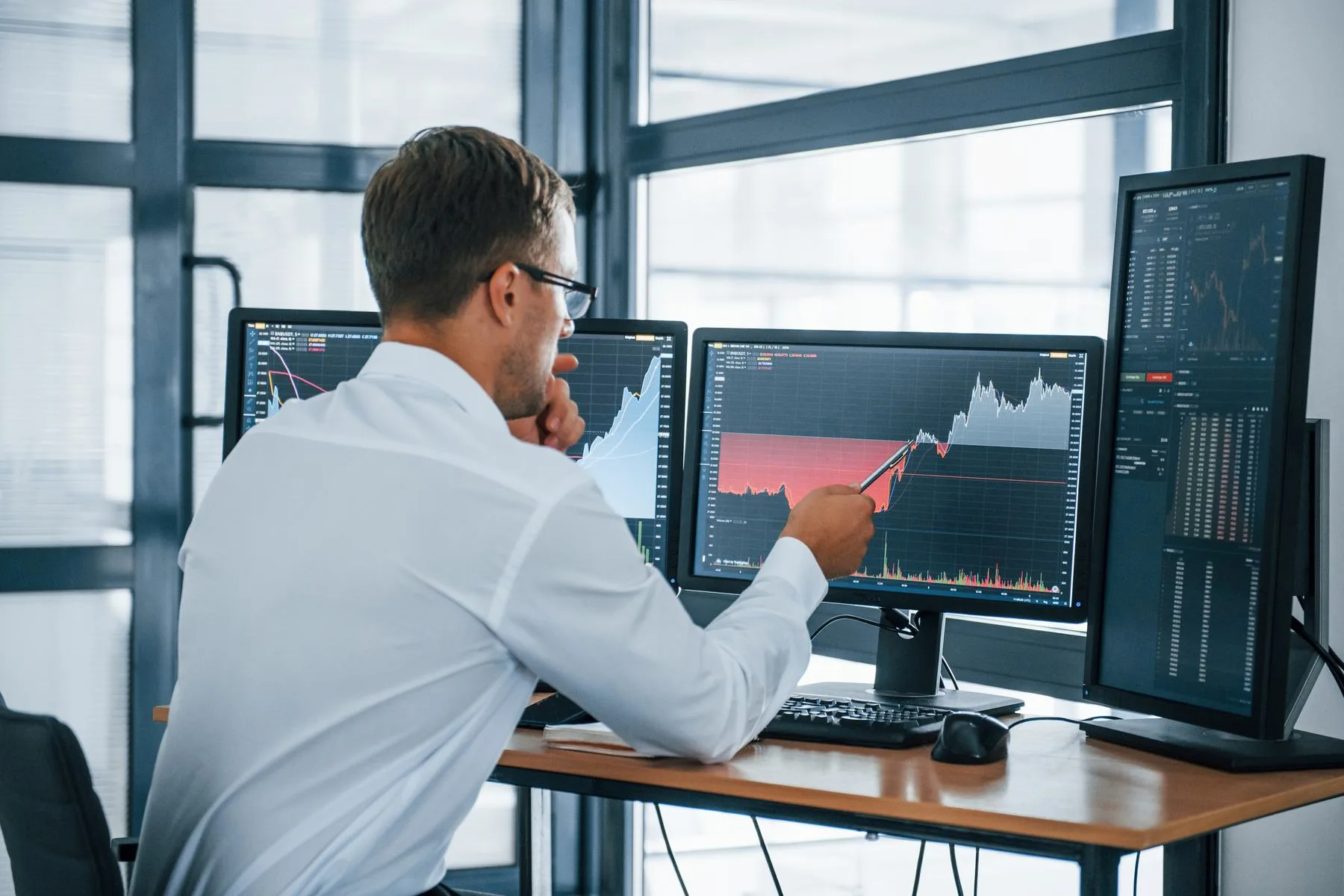 Man in office analyzing stock market data