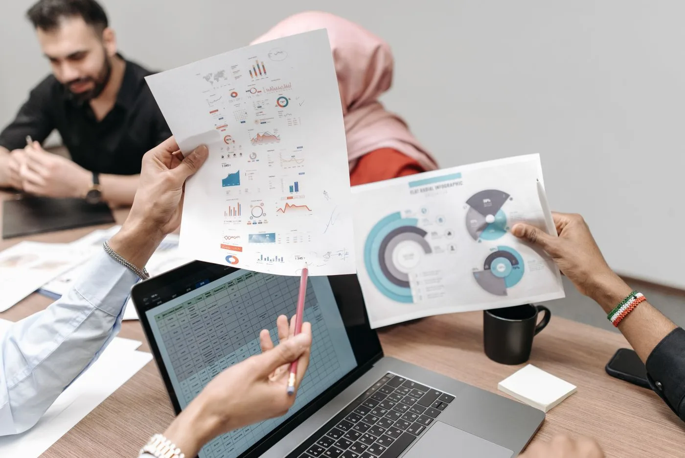 Team analyzing graphs and data during a business meeting